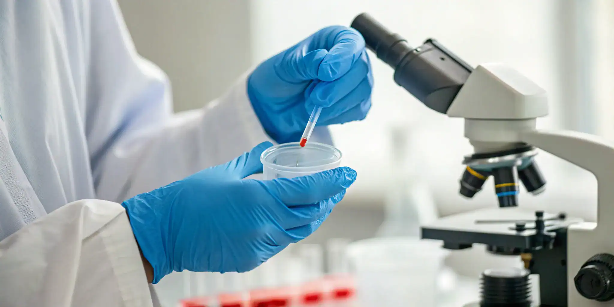Technician handling a blood sample for a free bloodborne pathogens certification.